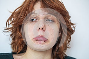 close-up portrait of a pensive teenage girl with red hair .