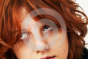 close-up portrait of a pensive teenage girl with red hair with a stylish