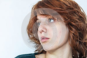 close-up portrait of a pensive teenage girl with red hair with a stylish