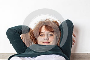 close-up portrait of a pensive teenage girl with red hair with a stylish