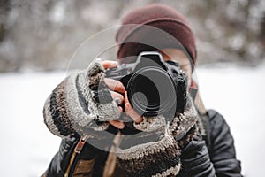 Close up portrait of photographer taking pictures with digital camera outdoor