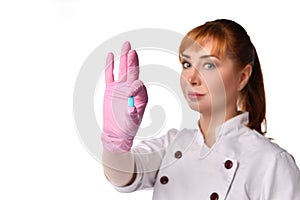 Close up portrait of positive woman doctor or nurse holding a tablet in fingers and looking at camera. Close up shot isolated on