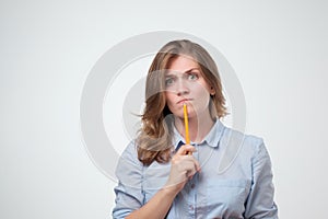 Close up portrait of pretty confident thoughtful girl, holding hand near the face, looking seriously