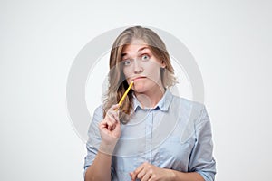 Close up portrait of pretty confident thoughtful girl, holding hand near the face, looking seriously