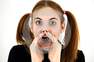 Close up portrait of pretty redhead teenage girl shouting