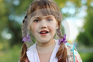 Close up portrait of pretty smiling little girl