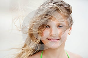 Close-up Portrait of a pretty smiling little girl with waving in