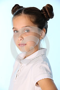 Close-up portrait of a pretty stylish brunette child girl looks seriously and attentively