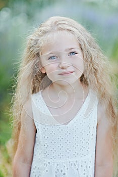 Close up portrait of pretty, young, blue eyed, fair skinned girl with happy and peaceful expression