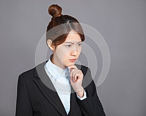 Close up portrait of pretty young business woman thinking