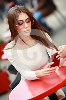 Close-up portrait of pretty young lady with stylish makeup and curly long hair. Big lips, soft skin and beautiful eyes