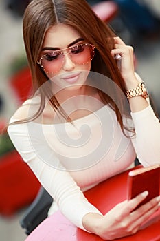 Close-up portrait of pretty young lady with stylish makeup and curly long hair. Big lips, soft skin and beautiful eyes