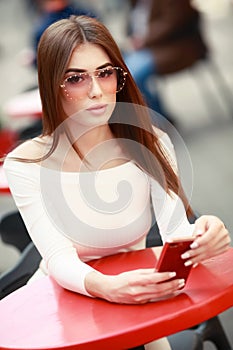 Close-up portrait of pretty young lady with stylish makeup and curly long hair. Big lips, soft skin and beautiful eyes