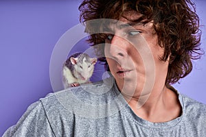 close-up portrait of rat sitting on male shoulder