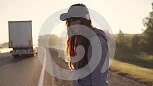 Close-up portrait of a red-haired girl with a piercing in the nose and lips and in the headphones. the hair fluttering