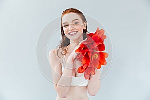 Close up portrait of a redheaded woman holding tulip flowers