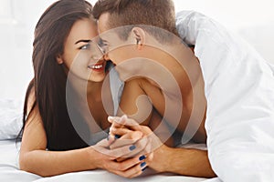 Close up portrait of romantic couple in bed photo