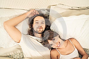 Close up portrait of romantic young couple in bed at home