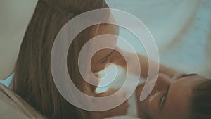 Close up portrait of romantic young man and woman in bed at home. Relationships, love, closeness.