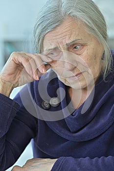 Close-up portrait of a sad elderly woman