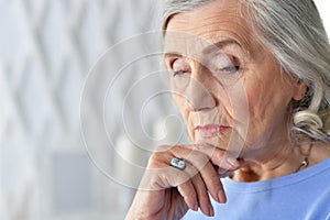 Close up portrait of sad ill senior woman