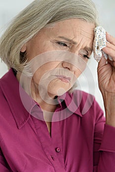 Close up portrait of sad ill senior woman