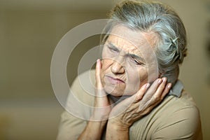 Close up portrait of sad ill senior woman