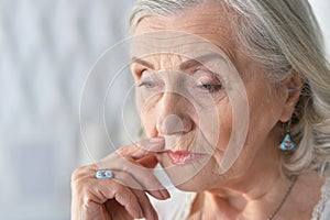 Close up portrait of sad ill senior woman