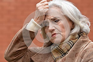 Close up portrait of sad ill senior woman