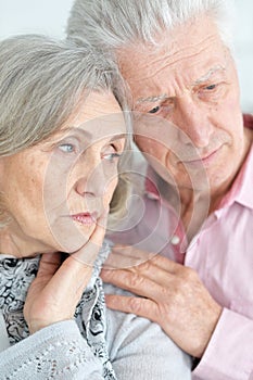 Close-up portrait of sad senior couple posing