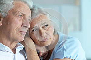 Close up portrait of sad senior couple posing