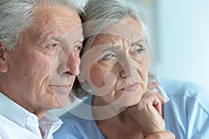 Close up portrait of sad senior couple posing