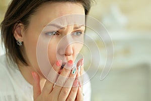 Close up portrait of sad young woman posing at home