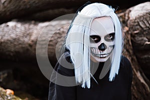 Close up portrait of scary woman with skeleton makeup.