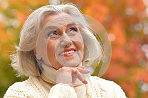 Close up portrait of senior beautiful woman in autumnal park
