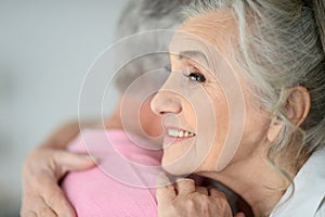 Close up portrait of senior couple hugging