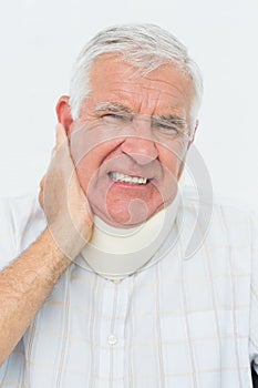 Close-up portrait of a senior man with cervical collar