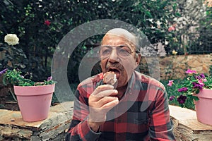 Close-up Portrait of senior man eating ice cream