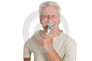 Close up portrait of senior man singing into microphone