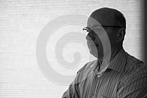 close-up portrait of a senior man thinking about something