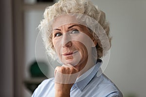 Closeup portrait senior woman posing looking at camera