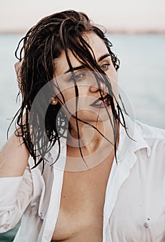 Close up portrait of sensual young woman with sand