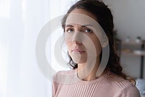 Close up portrait of serious joyless female photo