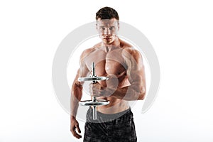 Close-up portrait of serious sweaty athletic man lifting dumbbell