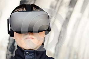 Close up portrait of a serious young man with vr glasses