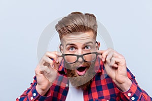 Close up portrait of shocked amazed man in checkered shirt touch photo