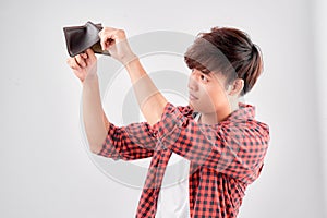 A close-up portrait of a shocked, surprised speechless man asia, holding an empty wallet