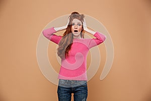 Close up portrait of a shocked young redhead girl