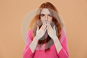 Close up portrait of a shocked young redhead girl