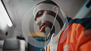 Close Up Portrait Shot of an African American Professional Paramedic Providing Medical Help to an